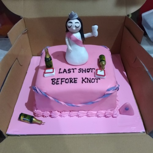 Pink Bridal Theme Bachelorette Cake featuring a bride figurine, champagne bottles, and "Last Shot Before Knot" text.